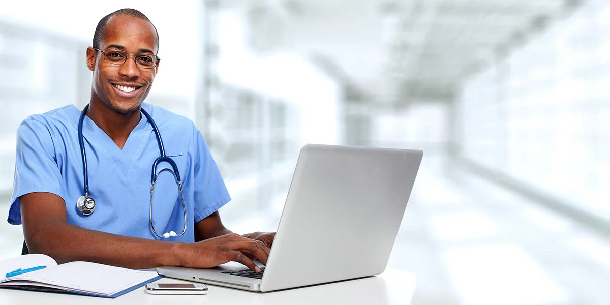 NCLEX JANUARY 2024 REVIEW Triangle Healthcare Consulting Services Inc   Male Nurse Smiling At Computer 1200x600 1.webp